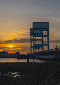 Built structure on field against sky during sunset