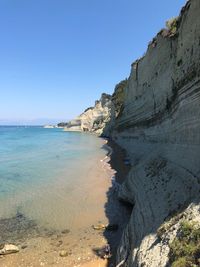 Scenic view of beach against clear blue sky