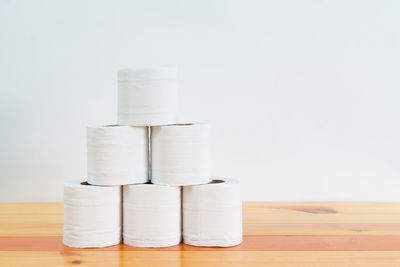 Close-up of stack on table against white background