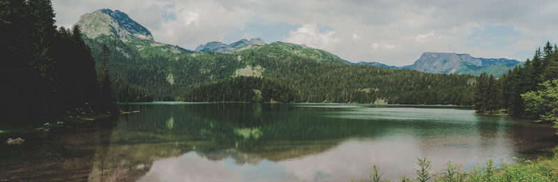 Scenic view of lake and mountains against sky