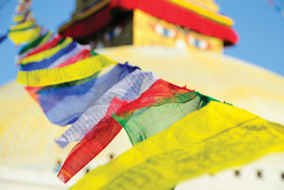 Close-up of colorful paper flags against sky