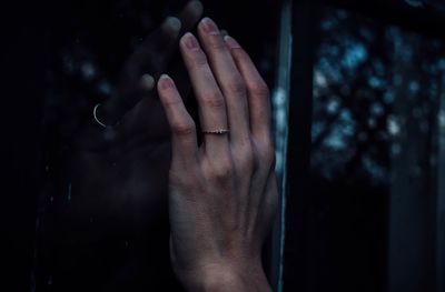 Close-up of hands touching glass