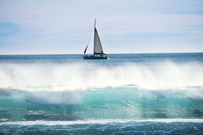 Boat sailing in sea against sky