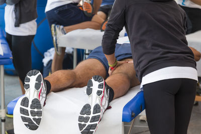 Trainers giving massage to athletes