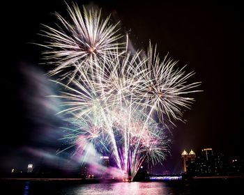 Low angle view of firework display in sky at night