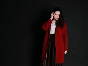 Young woman with red hair against gray background