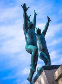 Low angle view of statue against blue sky