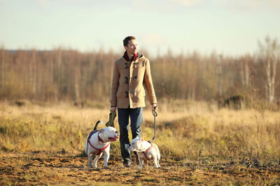 Full length of man with dogs standing on land