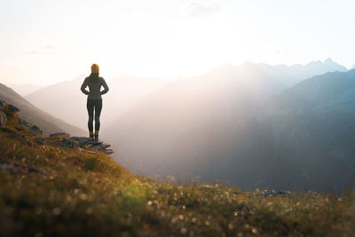 Rear view of man walking on mountain