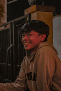 Portrait of smiling boy standing at home