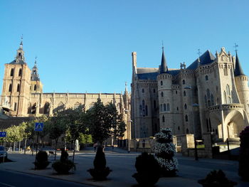 View of buildings against clear blue sky