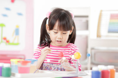 Cute girl painting at home