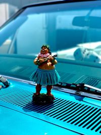 Rear view of woman standing by car