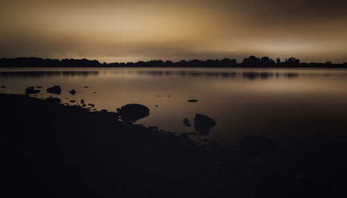 Scenic view of lake at sunset