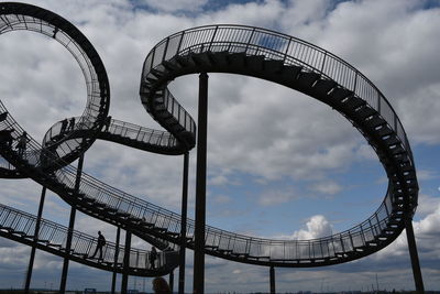 Low angle view of rollercoaster against sky