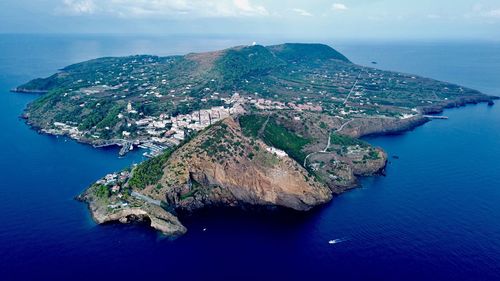 High angle view of island amidst sea against sky