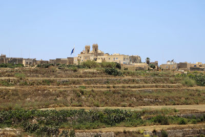 Scenic view of field against clear blue sky