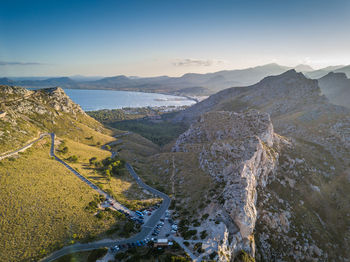 High angle view of river and mountains against sky