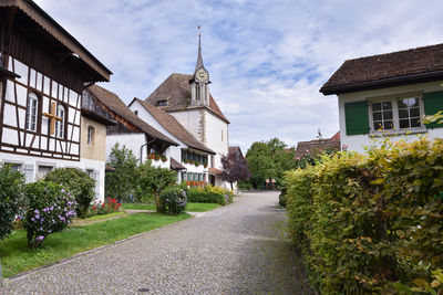 Trees and houses against sky