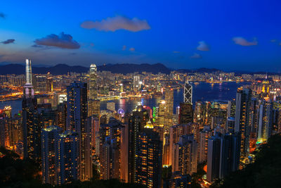 High angle view of illuminated cityscape against sky at night