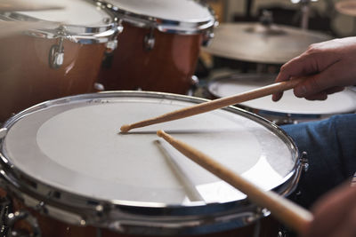 Cropped hand playing drum at workshop