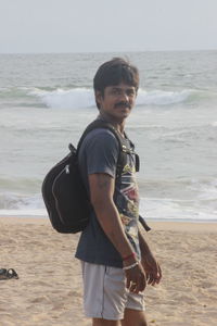 Full length of boy standing on beach