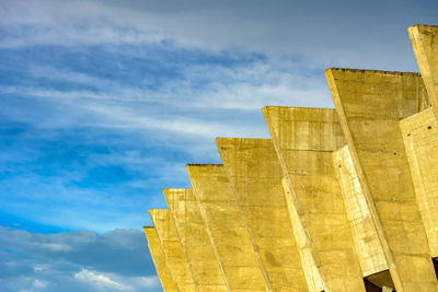 Low angle view of building against cloudy sky