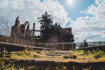 Low angle view of abandoned building against sky