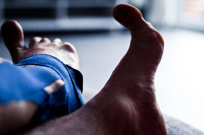 Low section of man relaxing on floor