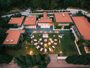 High angle view of houses amidst trees and buildings