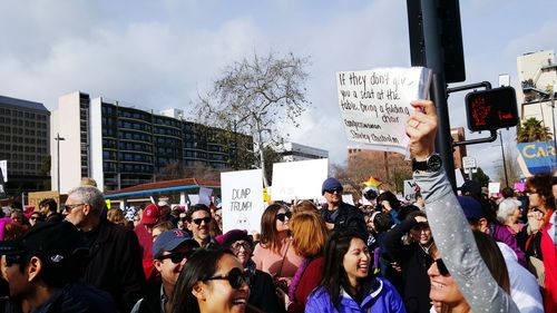 People on street against sky