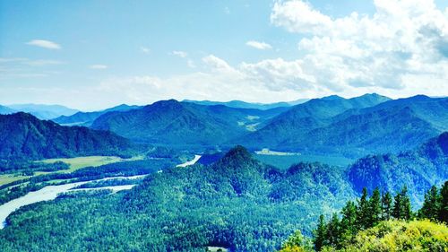 Scenic view of mountains against cloudy sky