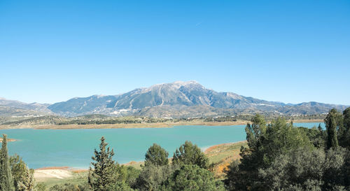 Scenic view of mountains against clear blue sky