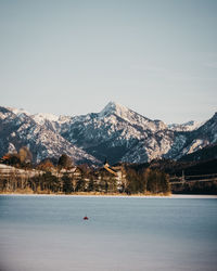 Scenic view of lake by houses during winter