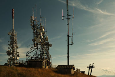 Low angle view of communications tower against sky