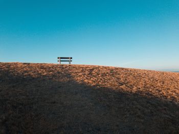 Scenic view of land against clear blue sky