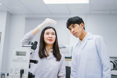 Portrait of young couple standing in corridor