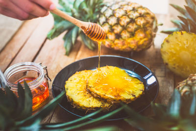 Close-up of person preparing food on table