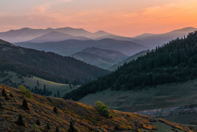 Scenic view of mountains against sky during sunset