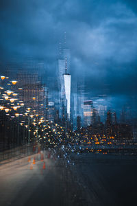 Illuminated buildings in city against sky at night