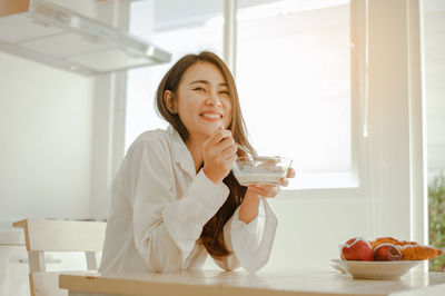 Young woman drinking glasses on table