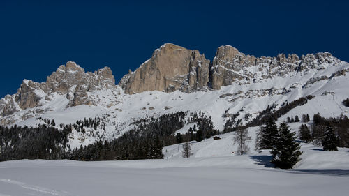 Scenic view of snowcapped mountains against clear blue sky