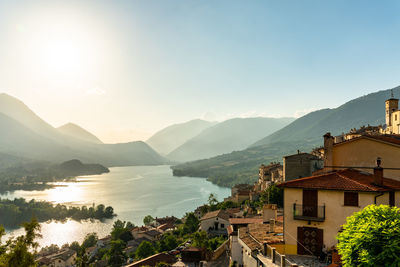 High angle view of townscape by mountains against sky