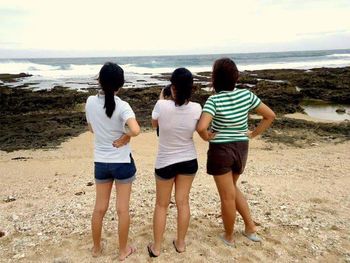 Friends standing on beach