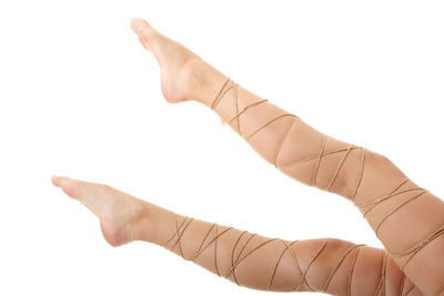 Close-up of hand touching finger against white background