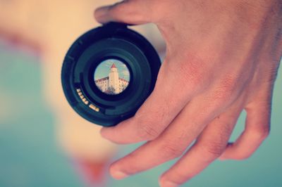 Close-up of man photographing camera