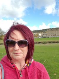 Portrait of woman with sunglasses against sky