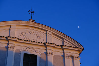 Low angle view of historical building against blue sky