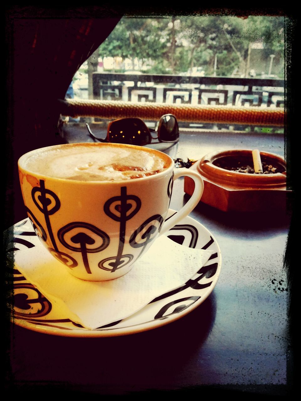 drink, food and drink, transfer print, table, refreshment, indoors, text, close-up, freshness, still life, auto post production filter, western script, frothy drink, coffee cup, communication, no people, drinking glass, glass - material, focus on foreground, coffee - drink