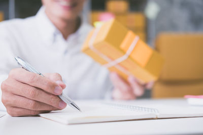 Close-up of man working on paper